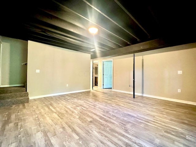 basement with hardwood / wood-style flooring