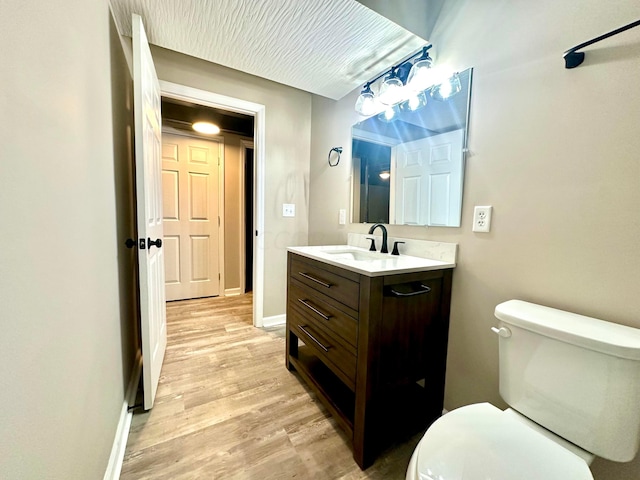 bathroom featuring hardwood / wood-style floors, vanity, and toilet