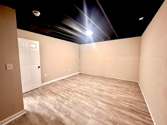 basement with light hardwood / wood-style flooring