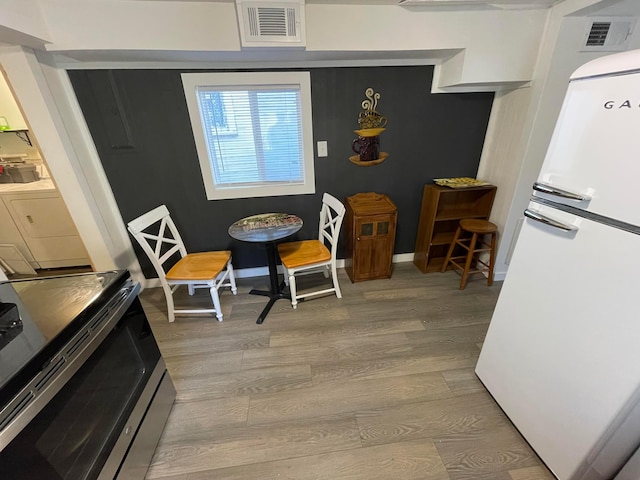 dining space with light hardwood / wood-style floors and washer / clothes dryer