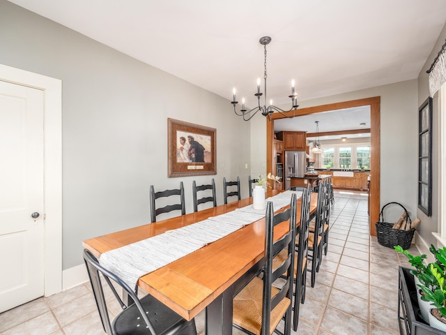 tiled dining space with a chandelier