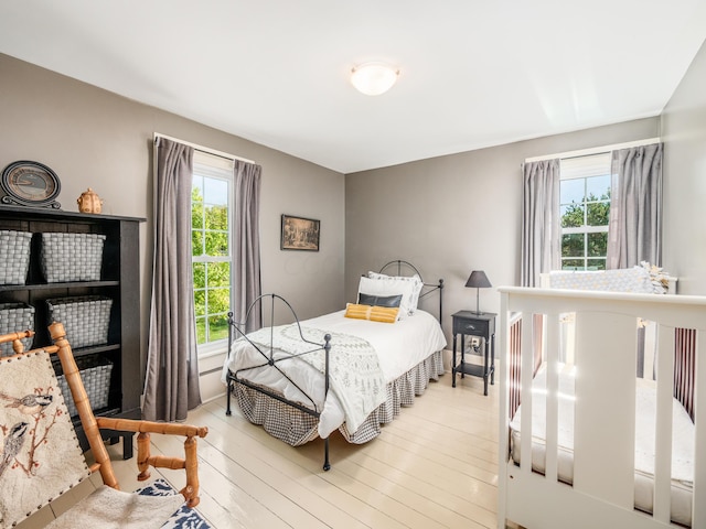 bedroom featuring light hardwood / wood-style floors and multiple windows