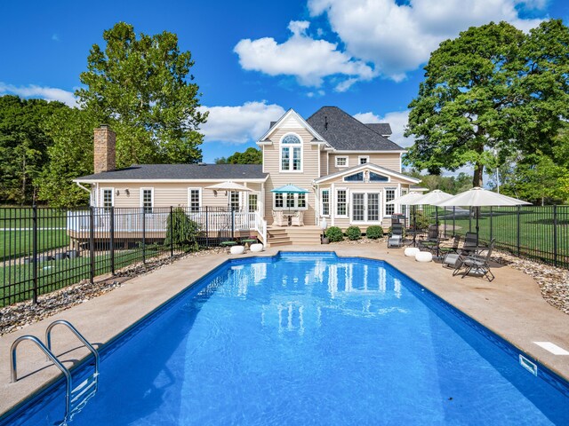 view of swimming pool featuring a patio area and a deck