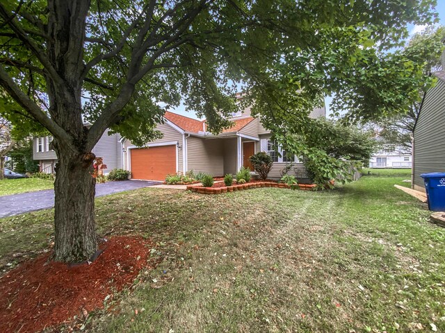 single story home with a front yard and a garage