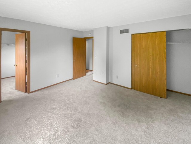 unfurnished bedroom featuring light colored carpet