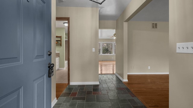 entryway with dark hardwood / wood-style floors and ceiling fan