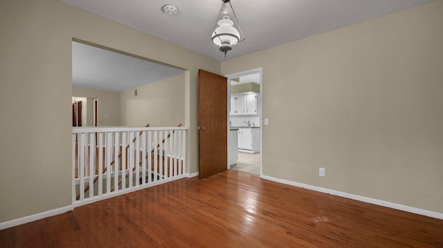 spare room featuring wood-type flooring