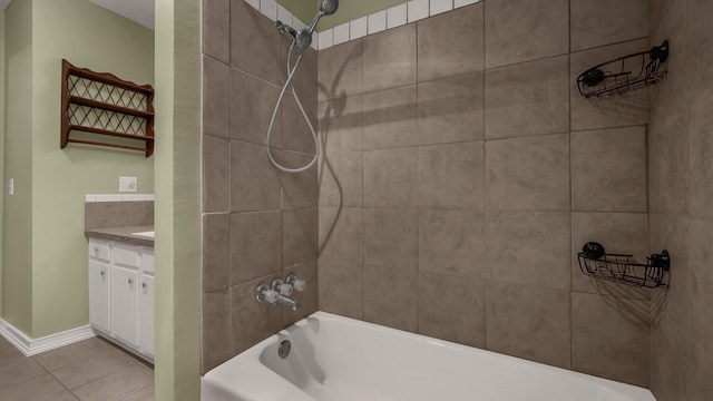 bathroom with tiled shower / bath, vanity, and tile patterned flooring