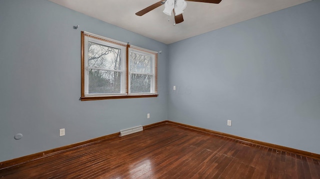 spare room featuring dark hardwood / wood-style floors and ceiling fan