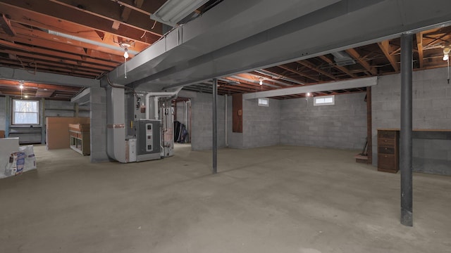 basement featuring heating unit and water heater