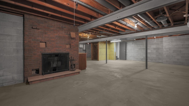 basement featuring a brick fireplace