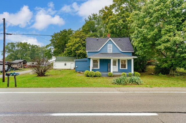 view of front of house with a porch and a front lawn