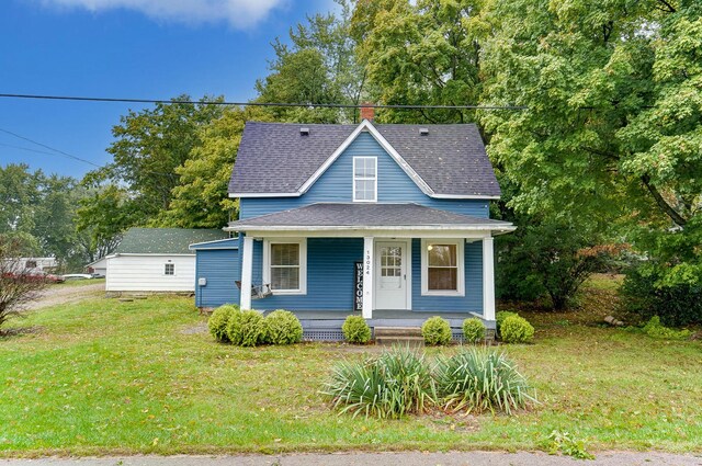 view of front of home with covered porch and a front yard