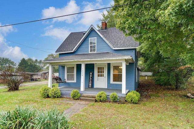 bungalow with covered porch and a front yard