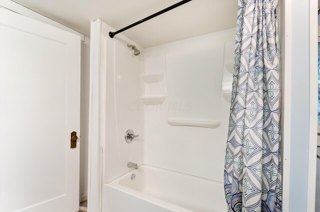 bathroom with shower / bath combination with curtain