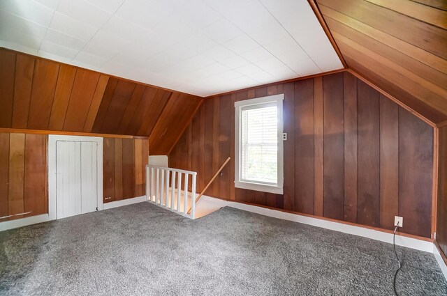 additional living space featuring lofted ceiling and carpet flooring