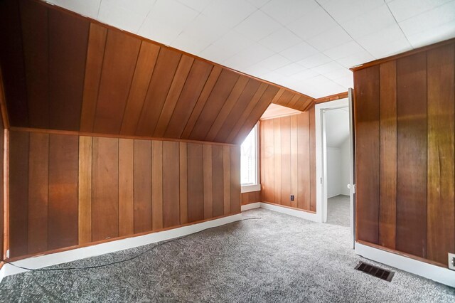 bonus room featuring light colored carpet and vaulted ceiling