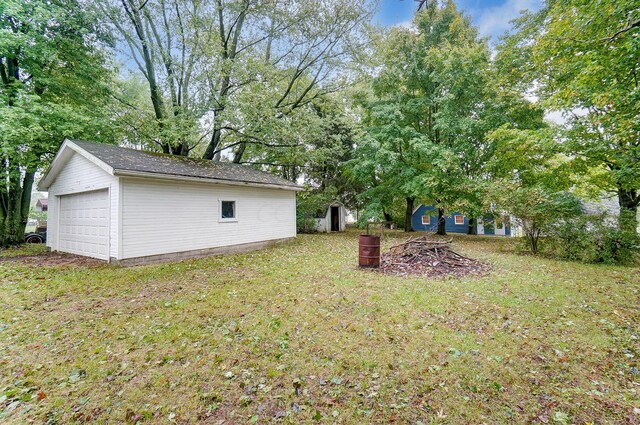 view of yard with a garage and a storage shed