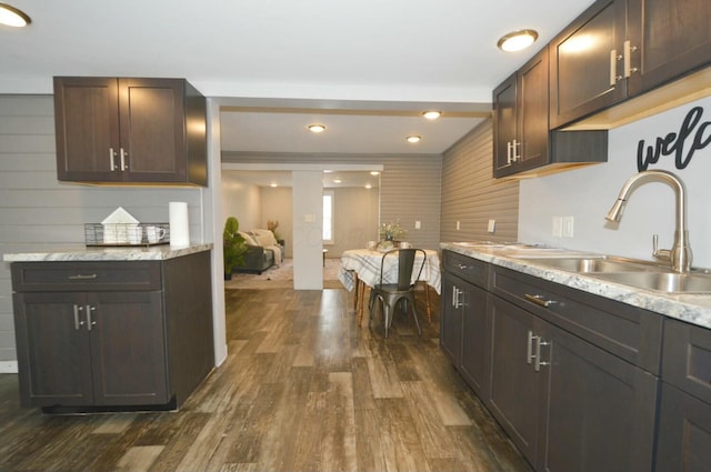 kitchen featuring sink, dark hardwood / wood-style floors, and dark brown cabinetry