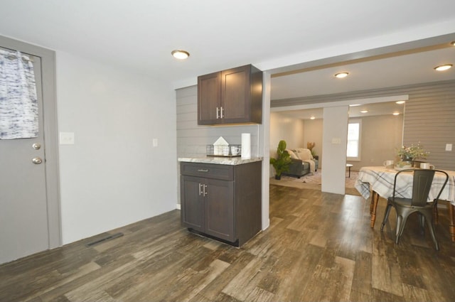 kitchen with dark hardwood / wood-style flooring and dark brown cabinetry