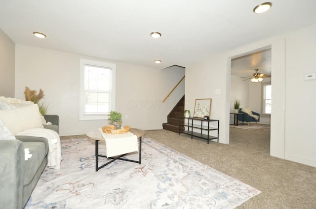 carpeted living room featuring ceiling fan