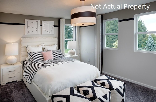 carpeted bedroom with multiple windows