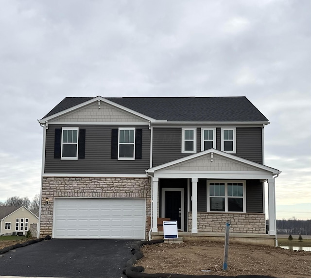 view of front of house with covered porch and a garage