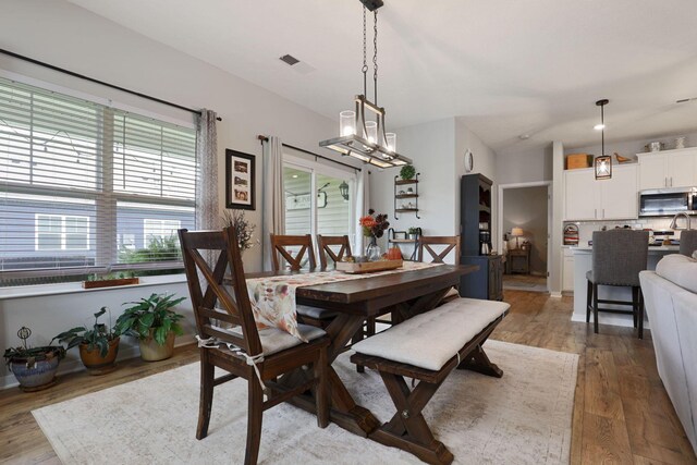 dining space with hardwood / wood-style flooring