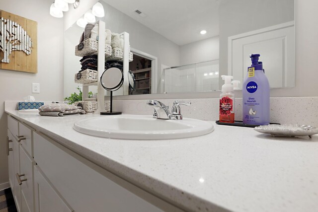 bathroom featuring vanity and walk in shower