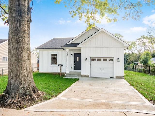 view of front of property with a garage and a front lawn