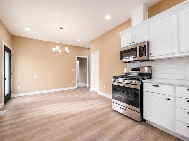 kitchen with white cabinetry, light hardwood / wood-style flooring, and stainless steel appliances