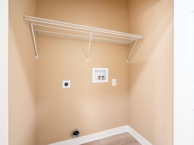 laundry room with electric dryer hookup, washer hookup, and hardwood / wood-style flooring