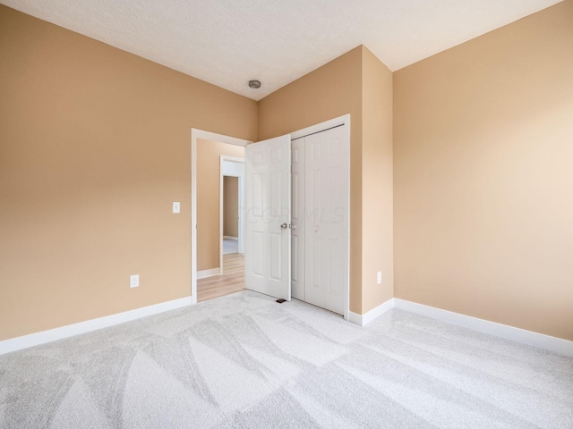 carpeted bedroom with a closet and a textured ceiling