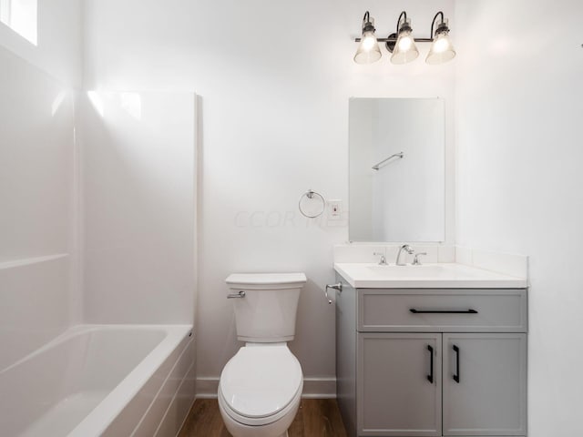 bathroom featuring hardwood / wood-style floors, vanity, and toilet