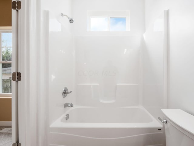 bathroom featuring bathing tub / shower combination and toilet