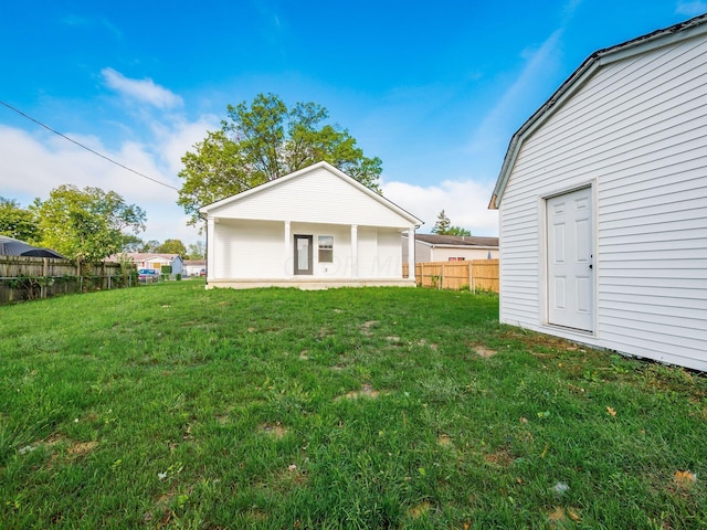 back of property featuring a yard