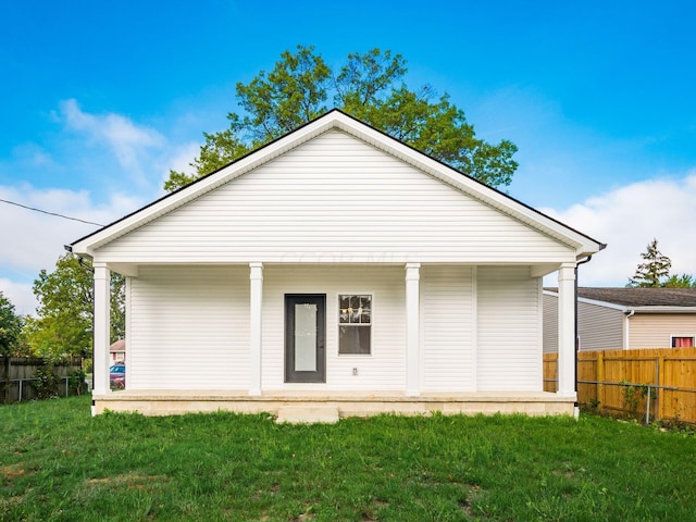 rear view of property with a yard and covered porch