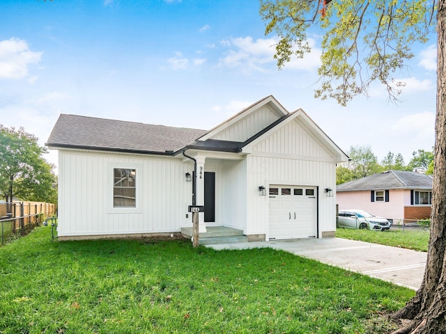 view of front of house with a garage and a front lawn