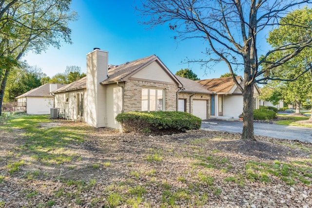 single story home with a garage and central AC