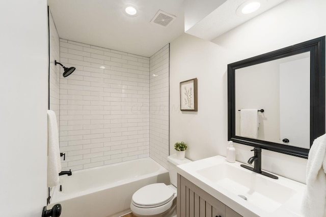 full bathroom with vanity, toilet, and tiled shower / bath