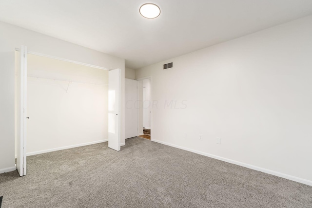 unfurnished bedroom with carpet and a closet