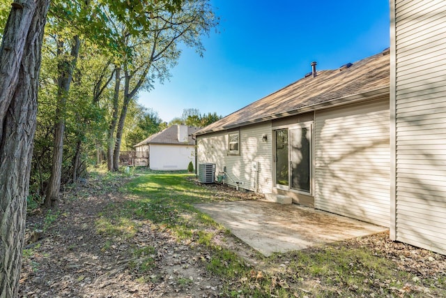 view of yard featuring central AC unit and a patio