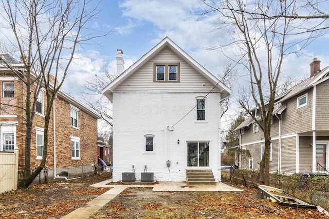 rear view of house featuring central air condition unit