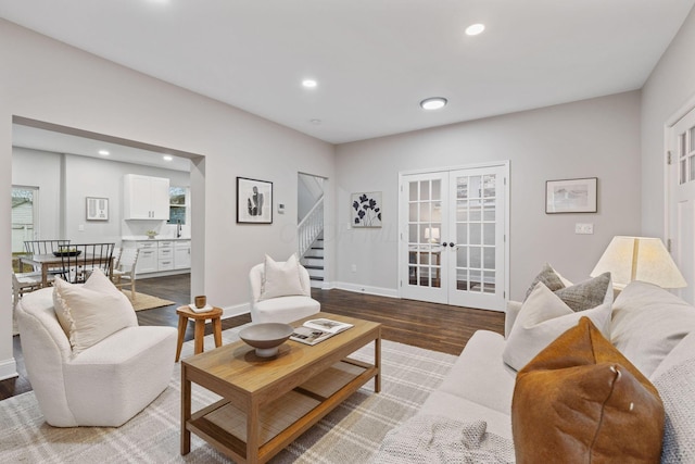 living room with light hardwood / wood-style flooring and french doors