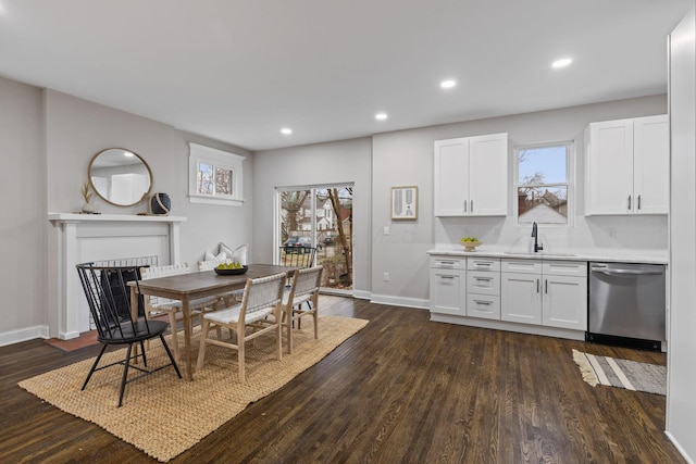 kitchen featuring white cabinetry, dark hardwood / wood-style floors, dishwasher, and sink