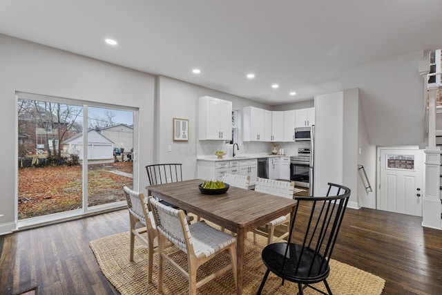 dining room with dark hardwood / wood-style flooring and sink