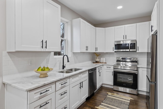 kitchen featuring sink, dark hardwood / wood-style floors, white cabinets, and appliances with stainless steel finishes