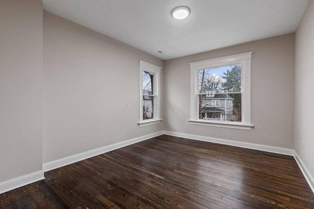 empty room featuring dark wood-type flooring