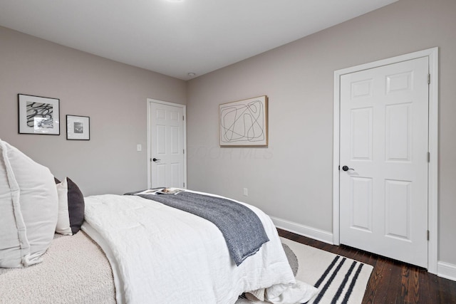 bedroom with dark wood-type flooring