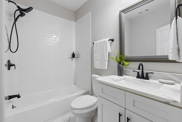 full bathroom with vanity, tiled shower / bath, and toilet